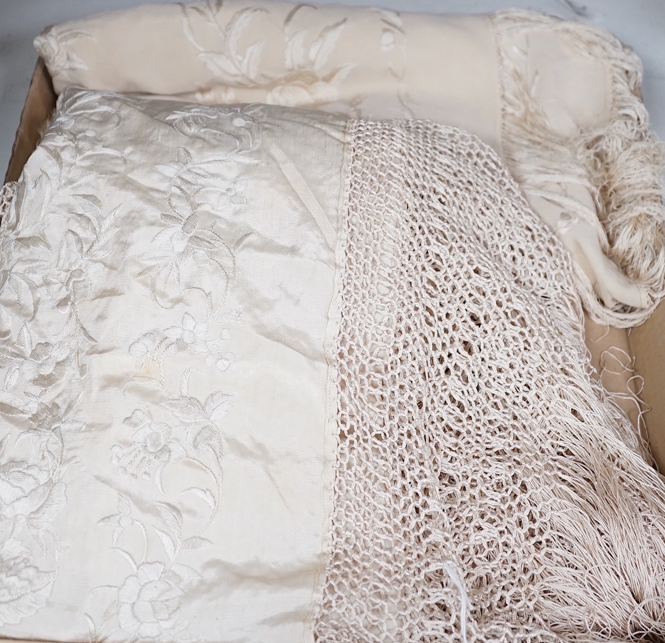 A 19th century cream embroidery on cream silk shawl together with a smaller later shawl